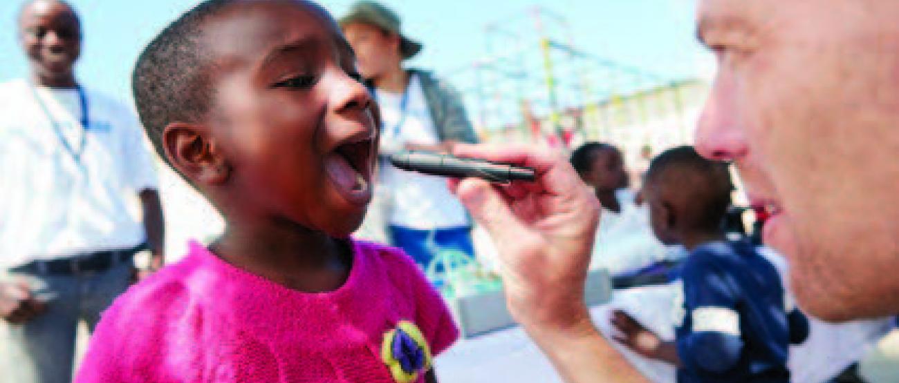 Shot of a volunteer doctor giving checkups to underprivileged kids